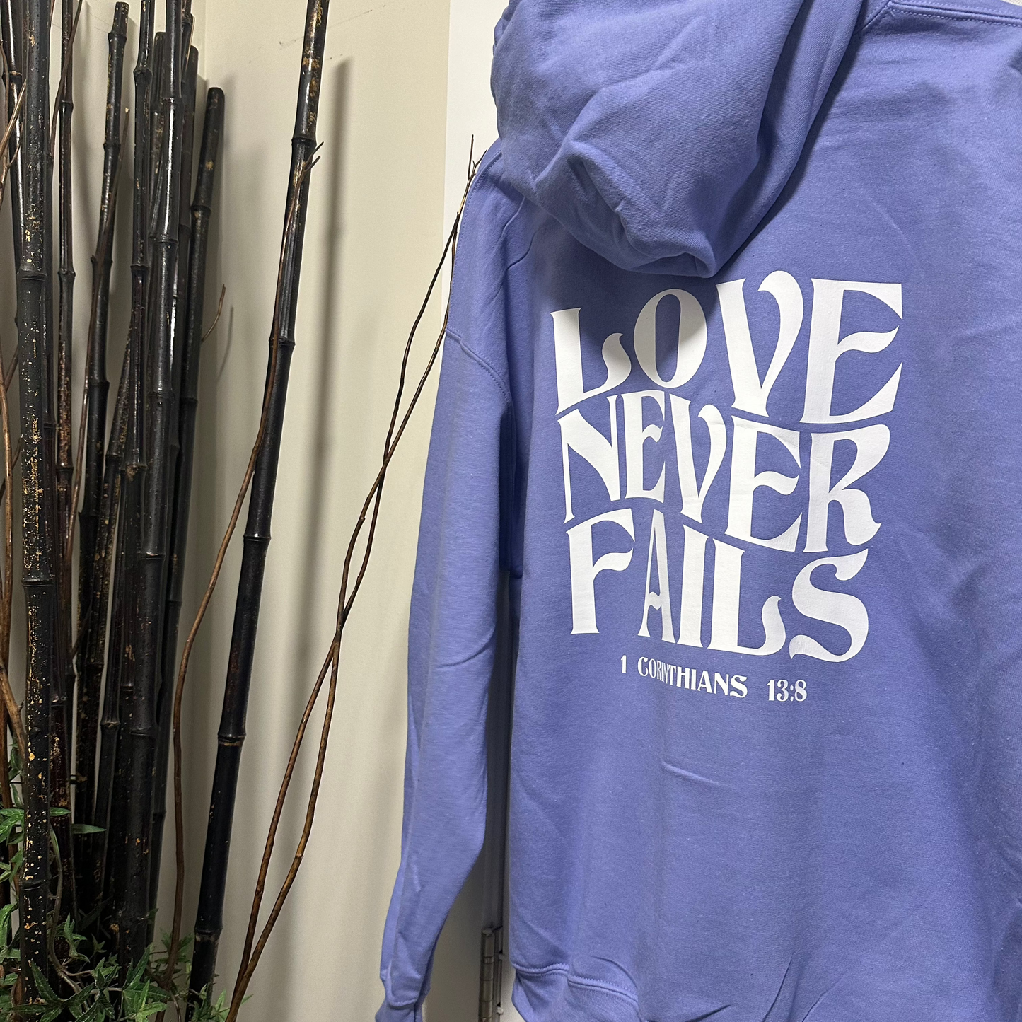 “Love Never Fails" Hooded Sweatshirt